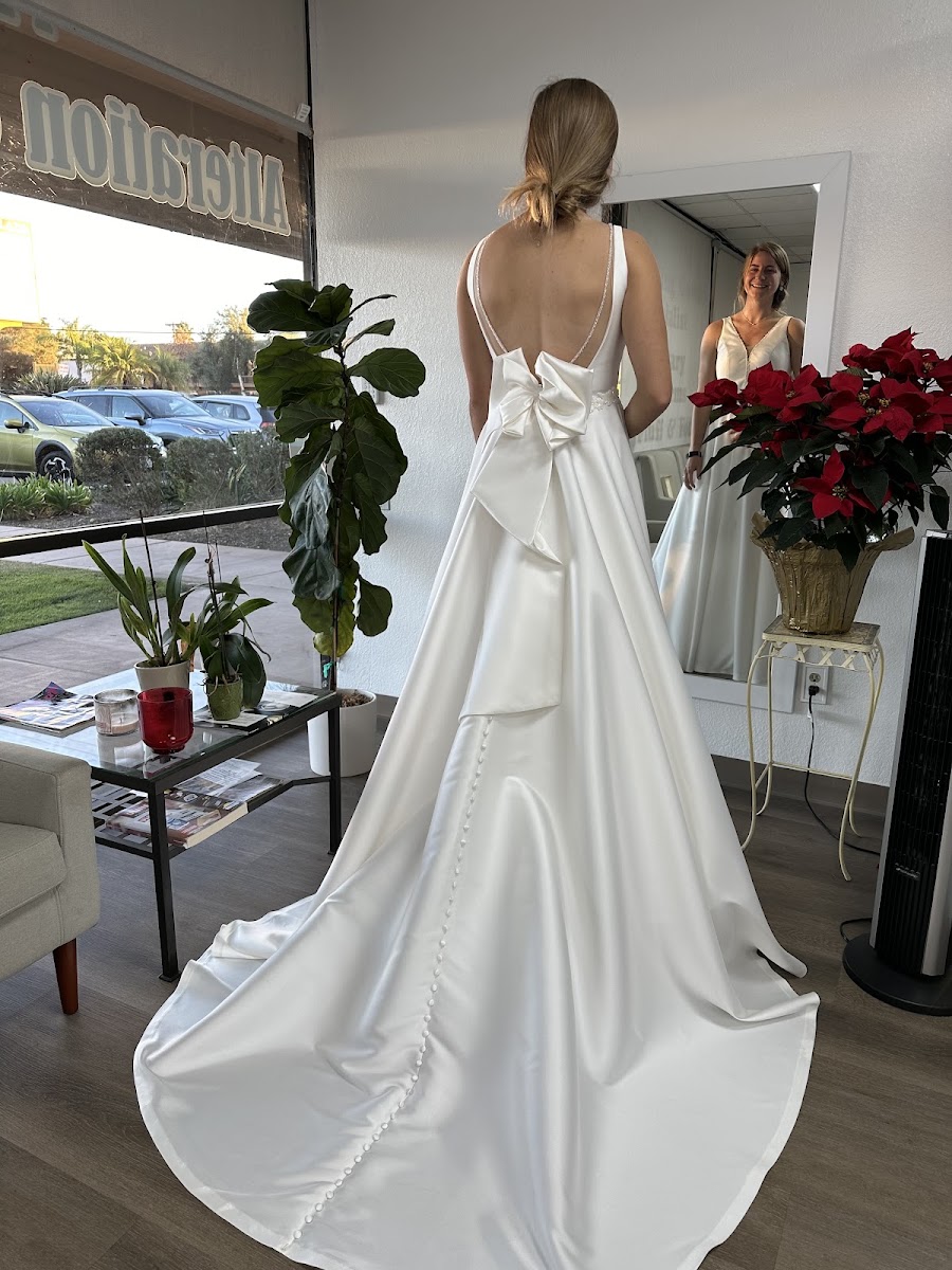 Satin wedding gown with a bow back and flowing train