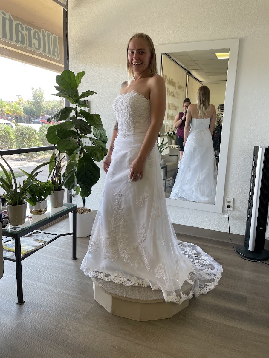 Strapless lace wedding gown on the fitting pedestal
